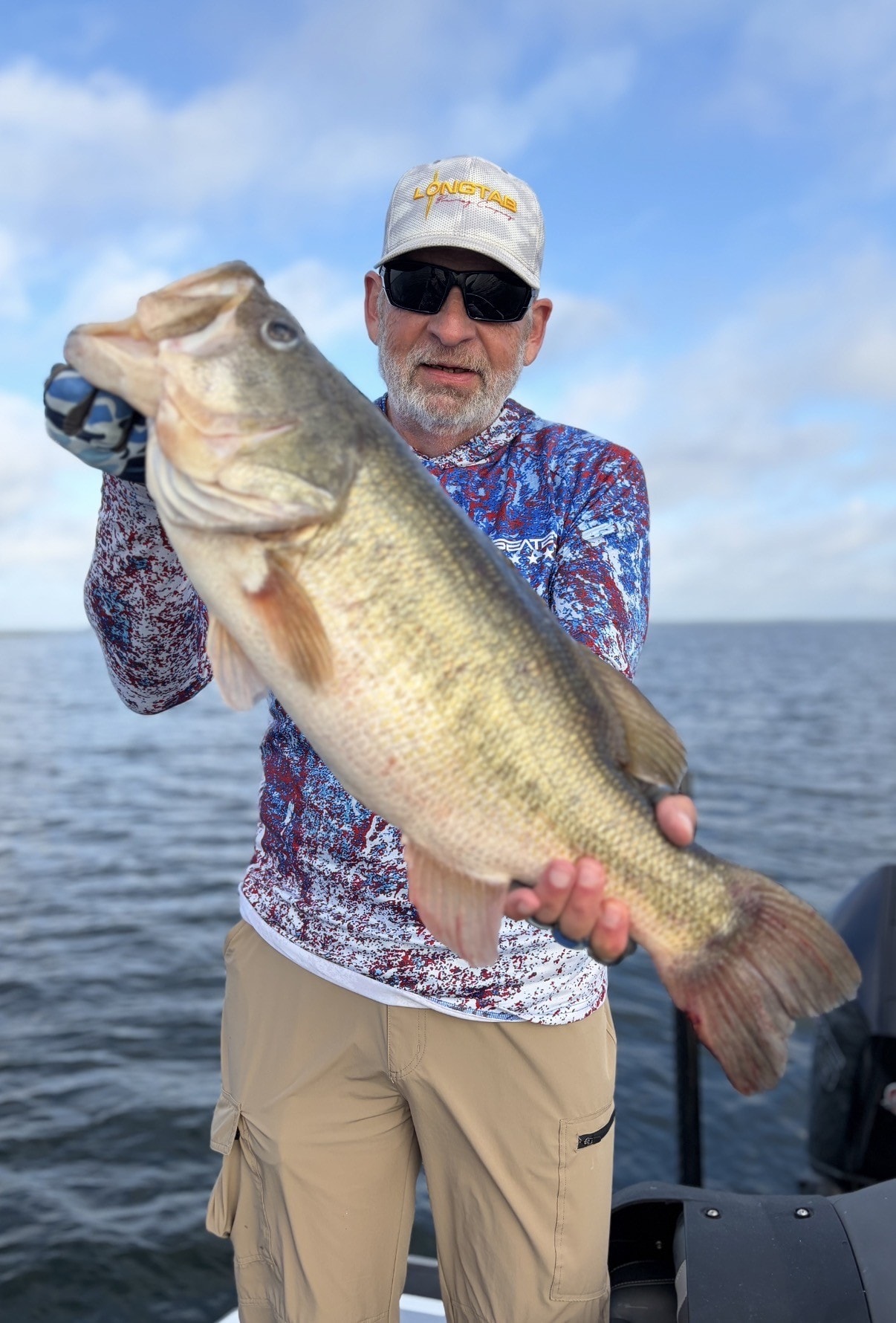 Angler with trophy largemouth bass on Lake Falcon