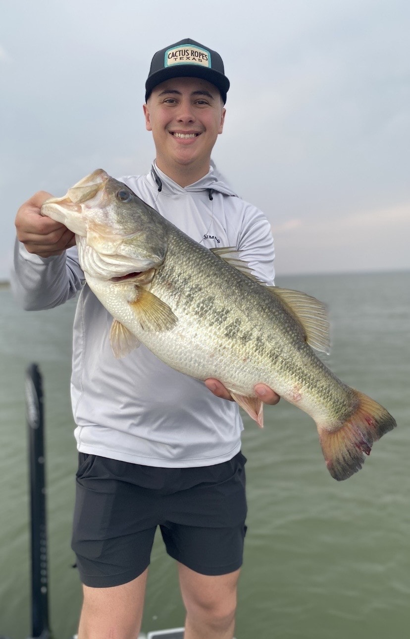 Angler in Cactus Ropes cap with big bass