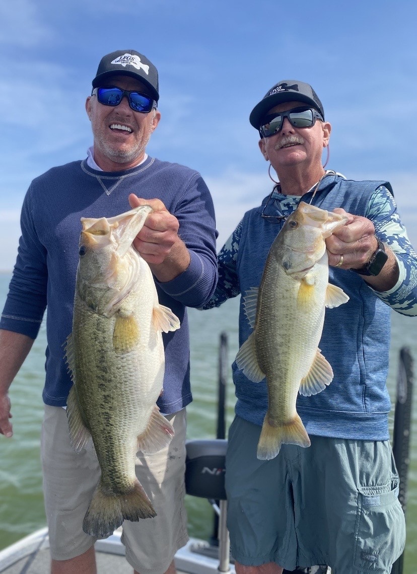 Two anglers in LFGS caps with largemouth bass
