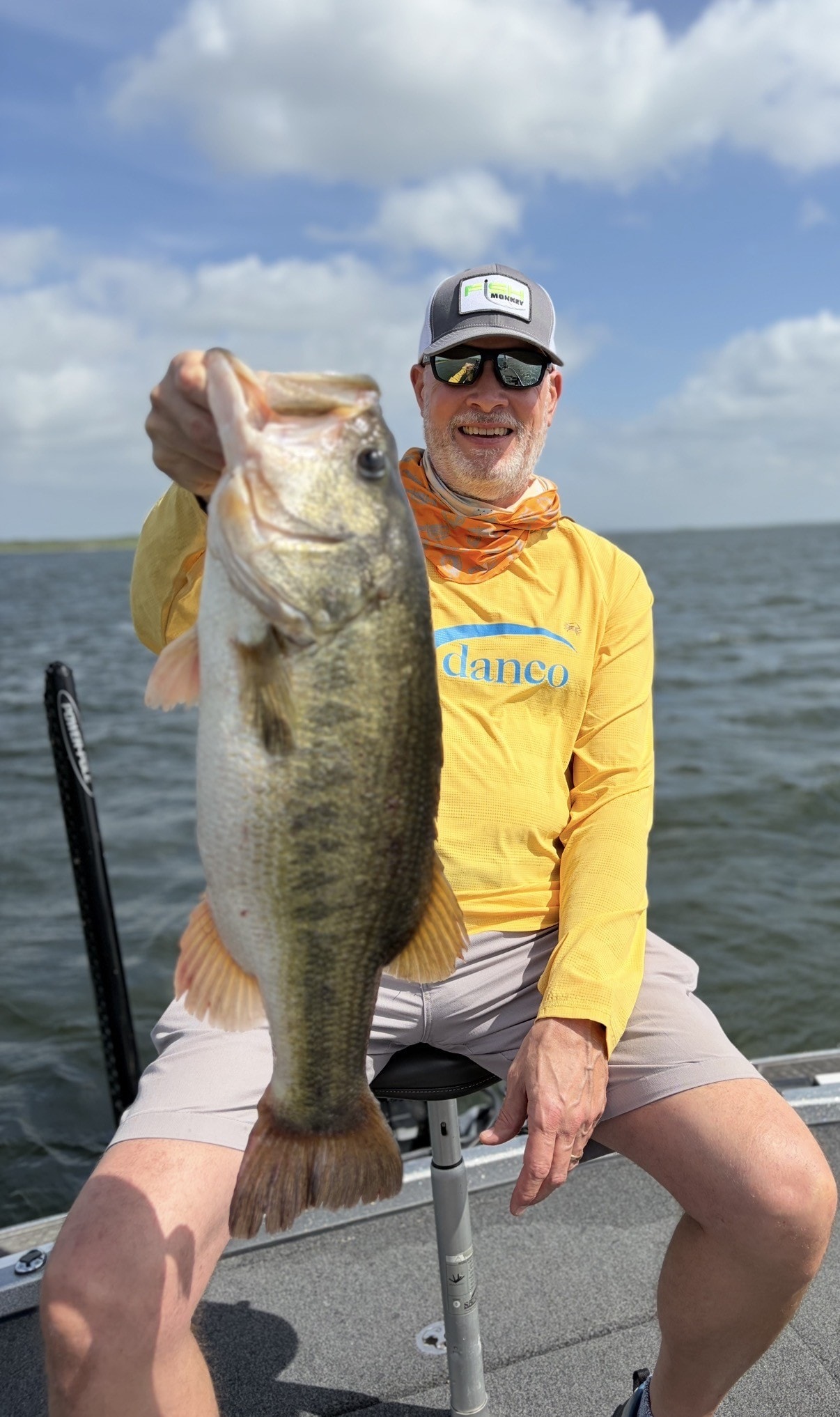 Angler holding large bass on boat
