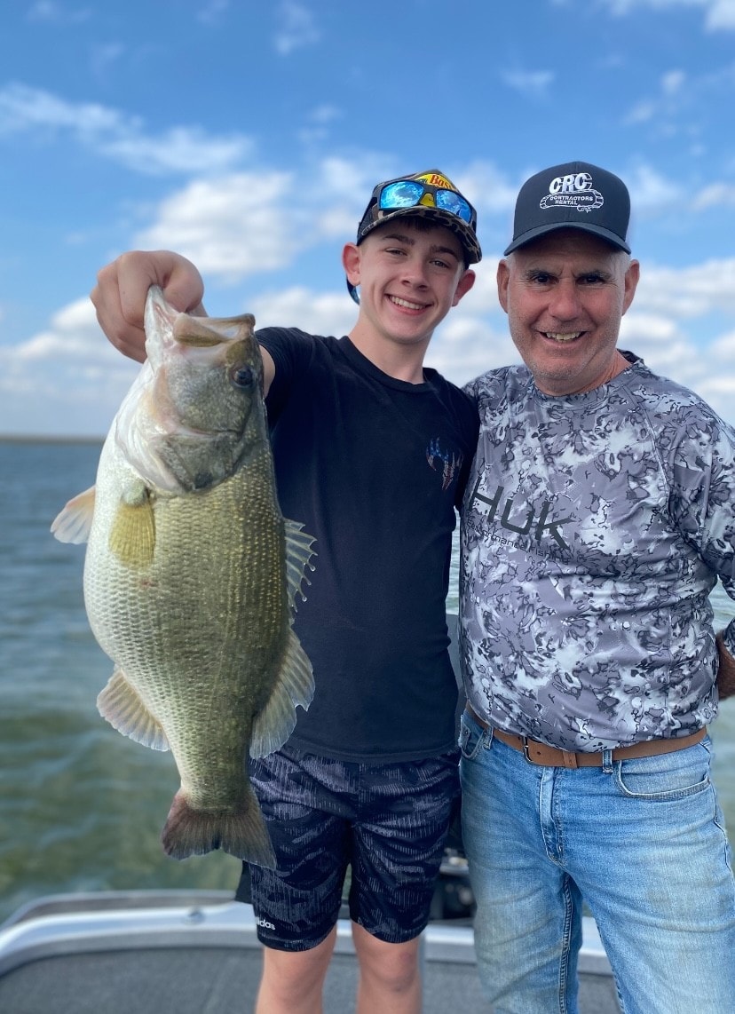 Teen and dad with big bass on Lake Falcon