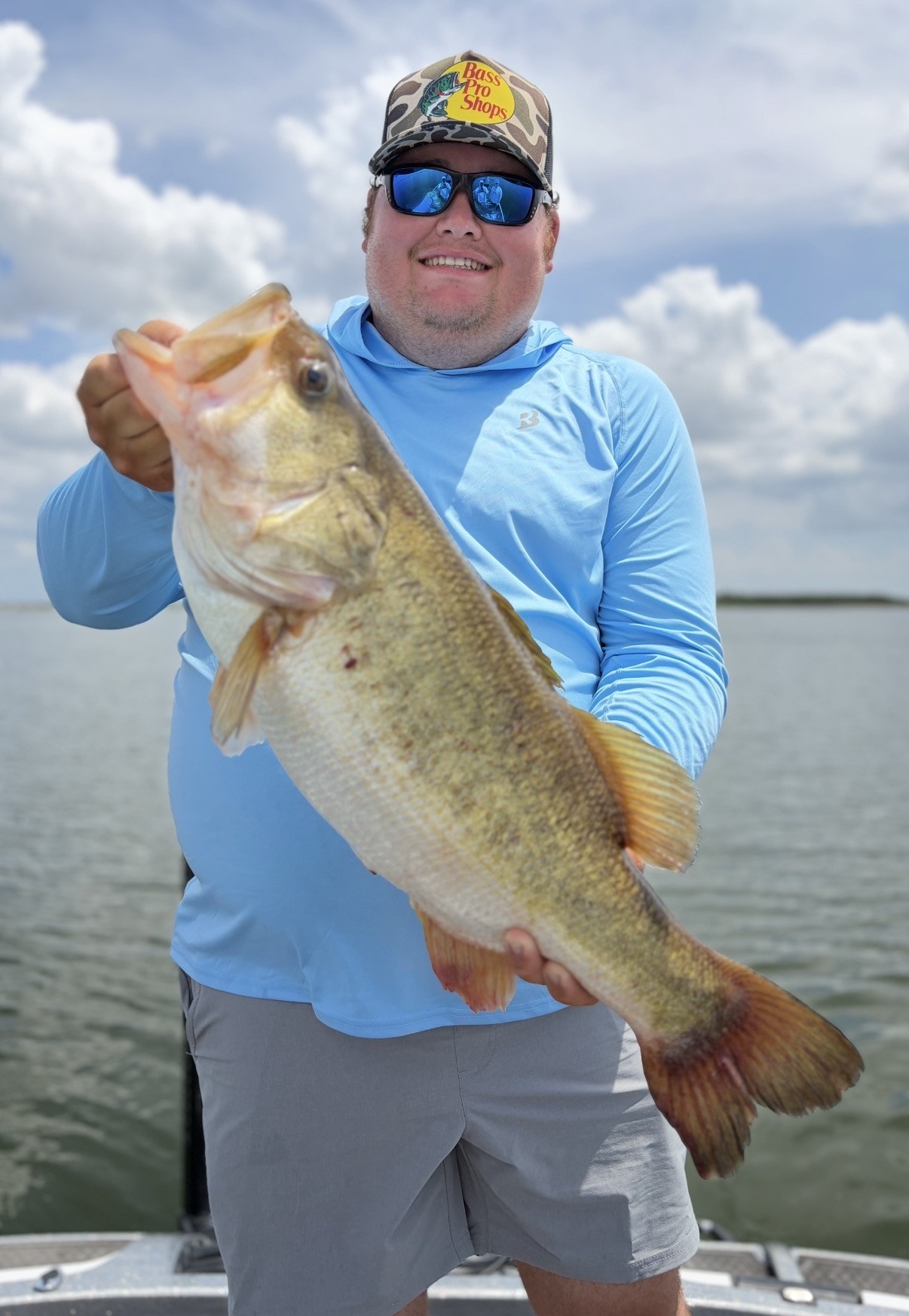 Angler with largemouth bass Lake Falcon