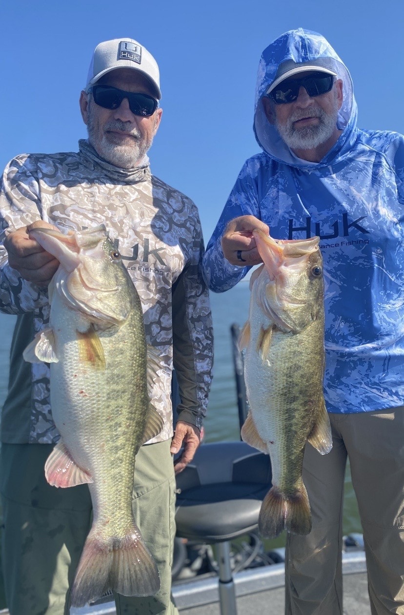 Two anglers with trophy bass catches